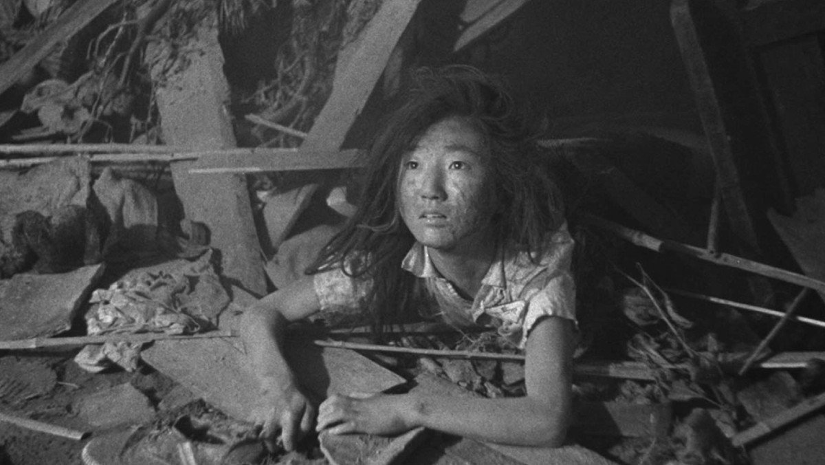 Still of a young girl in rubble in the movie Hiroshima, a movie to watch after Oppenheimer.