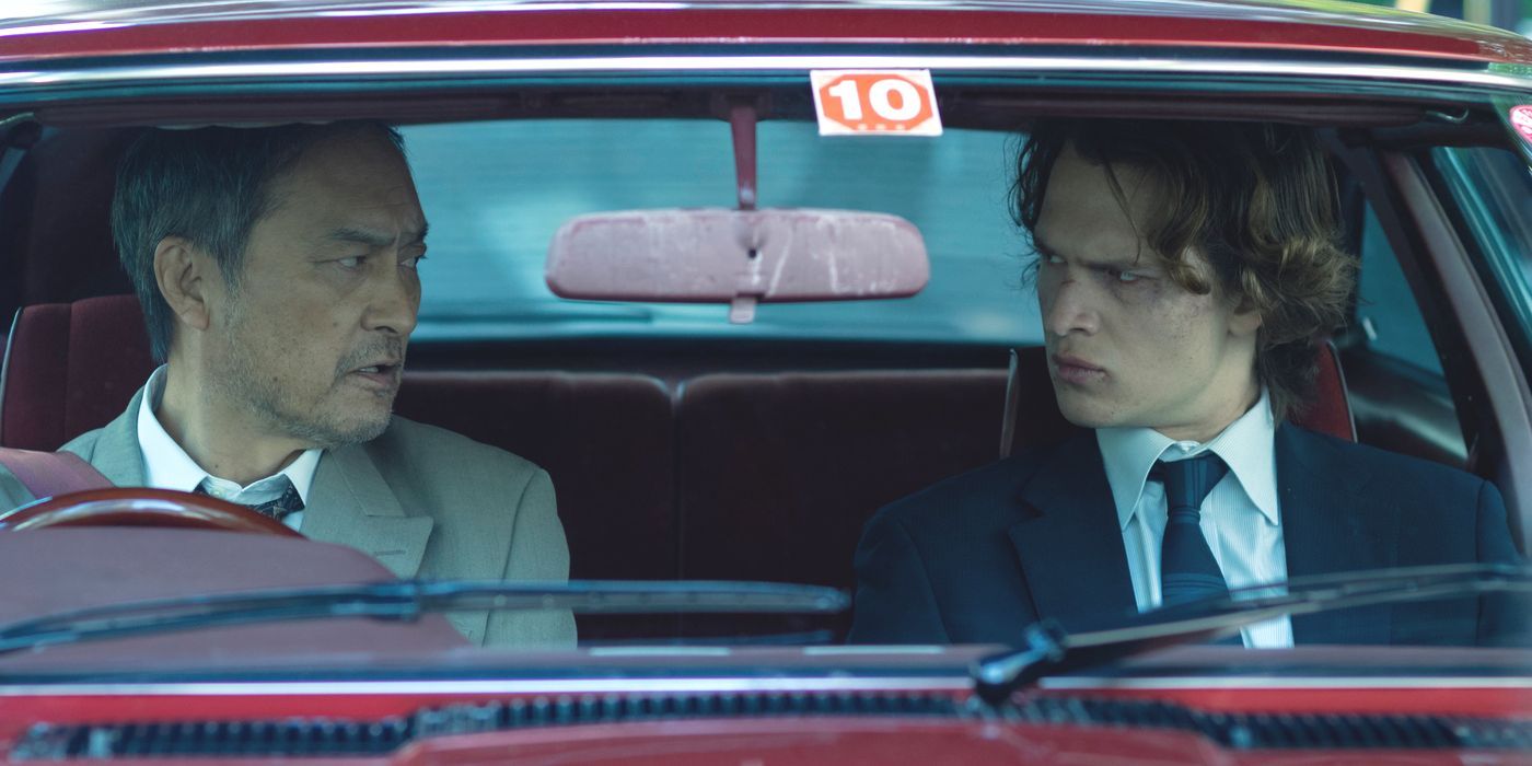 Katagiri (Ken Watanabe) talks to Jake (Ansel Elgort) in a red car in Tokyo Vice Season 2.