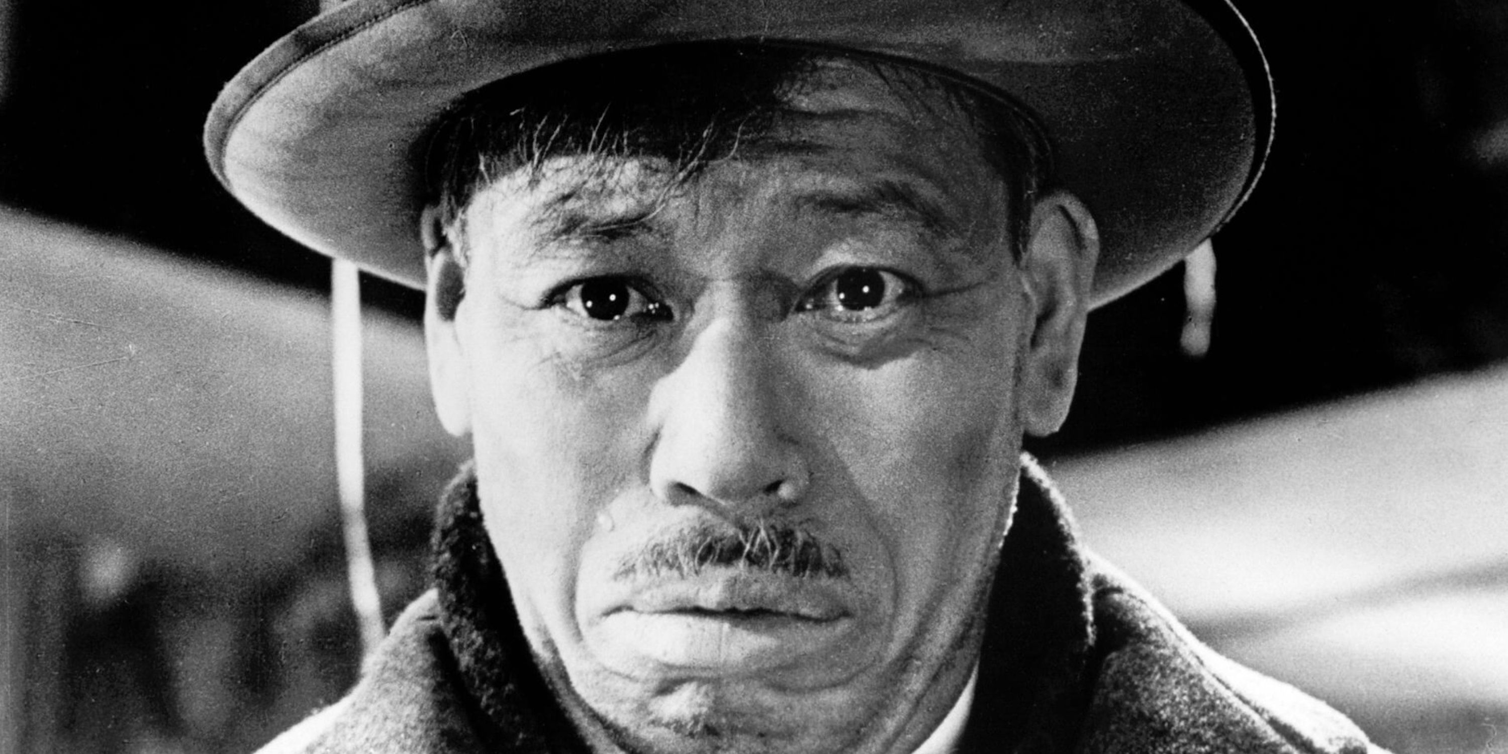 A closeup shows Takashi Shimura, a prominent 20th-century Japanese actor, looking sad.